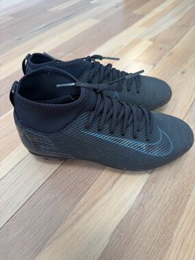 Nike Black High-Top Soccer Cleats with Subtle Blue Swoosh